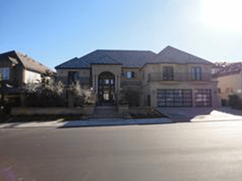 Large two-story house featuring a grand entrance