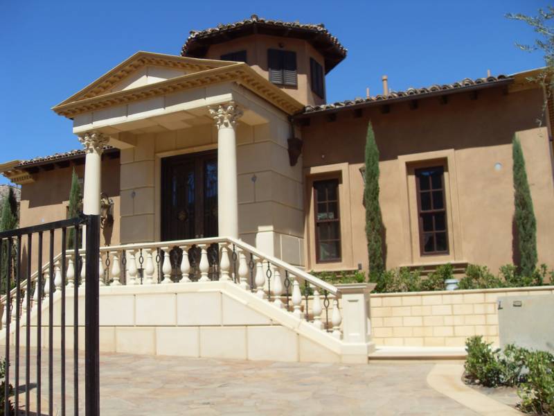 house featuring a grand entrance with columns and a staircase