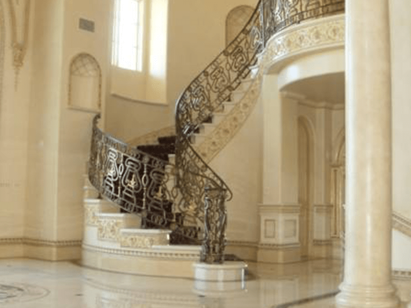 Elegant spiral staircase with ornate iron railing